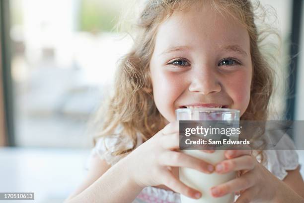 girl drinking glass of milk - milk stockfoto's en -beelden