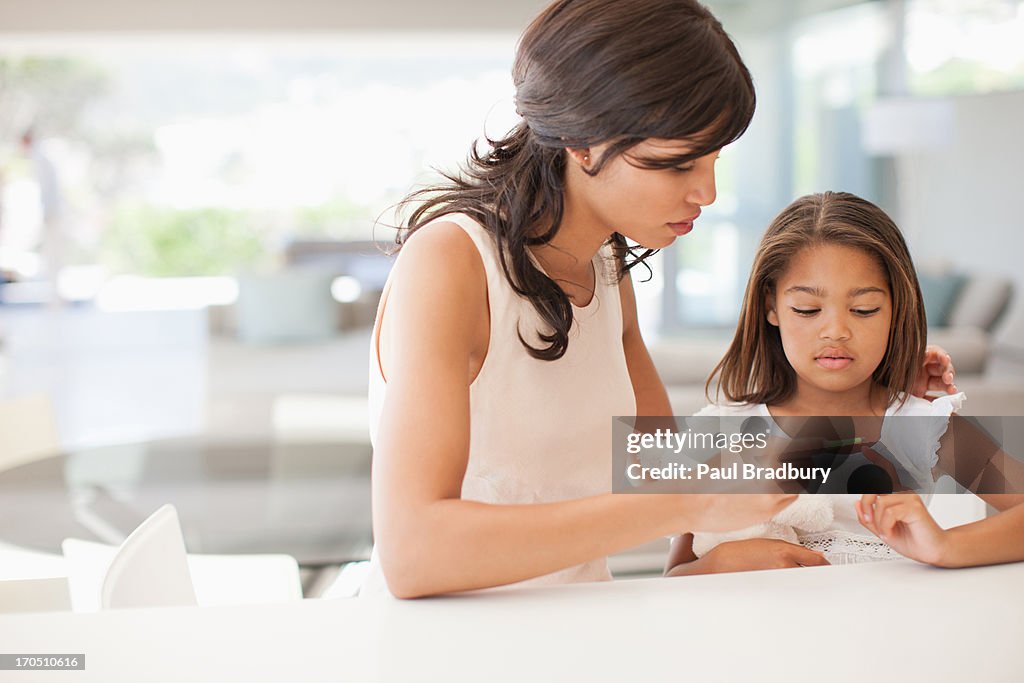 Mother taking daughters temperature