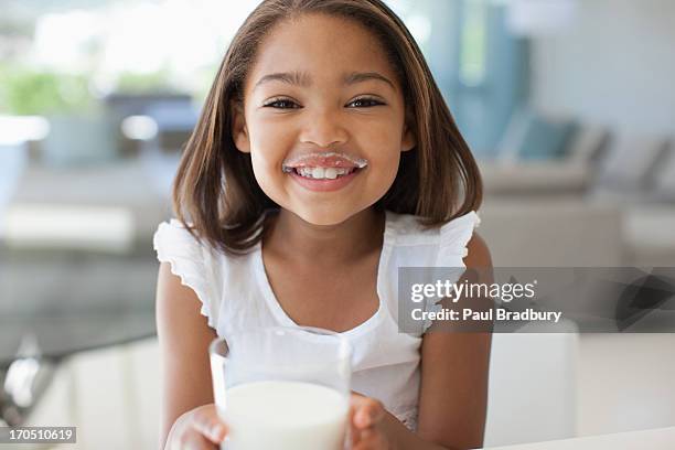 girl drinking glass of milk - milk moustache stock pictures, royalty-free photos & images