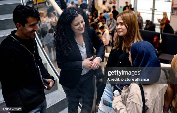 October 2023, Berlin: Cansel Kiziltepe , Senator for Labor of Berlin, talks to refugees at the job fair "FuTog Berlin". The 12 Berlin Job Centers,...