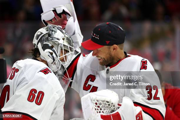 Yaniv Perets of the Carolina Hurricanes is congratulated on the win by teammate Antti Raanta following their 4-1 win over the Florida Panthers at PNC...