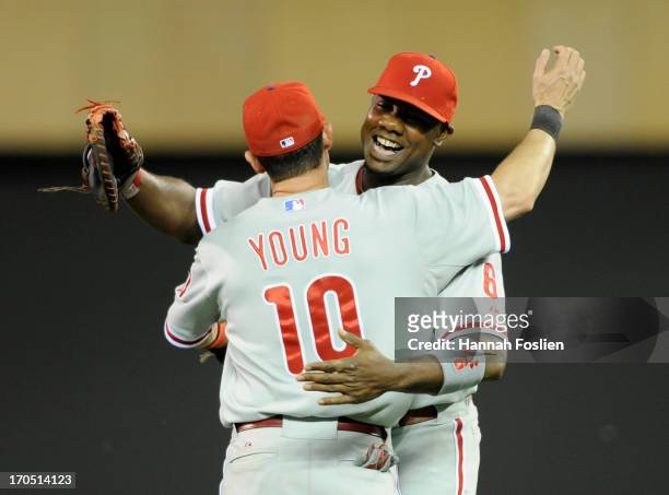 Michael Young and Ryan Howard of the Philadelphia Phillies celebrate a win against the Minnesota Twins on June 13, 2013 at Target Field in...