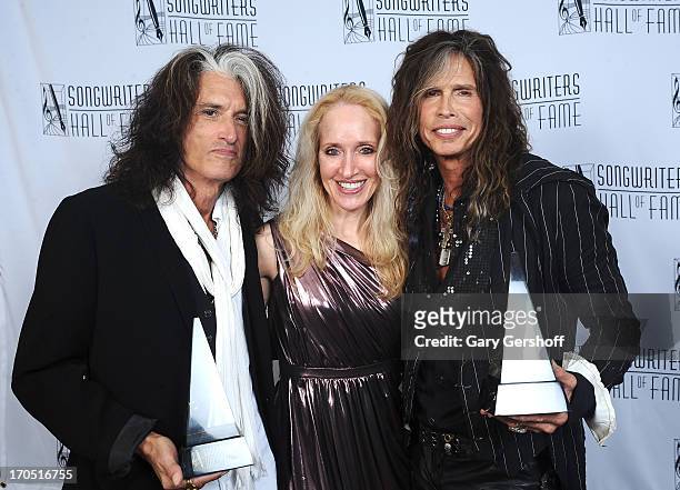 Joe Perry and Steven Tyler of Aerosmith pose with April Anderson at Songwriters Hall of Fame 44th Annual Induction and Awards Dinner at the New York...