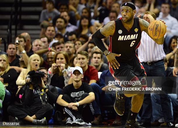 LeBron James of the Miami Heat looks on as he dribbles up the court against the San Antonio Spurs during game 4 of the NBA finals on June 13, 2013 in...