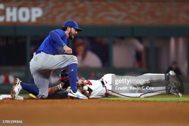 Ronald Acuna Jr. #13 of the Atlanta Braves steals second base against Dansby Swanson of the Chicago Cubs in the 10th inning at Truist Park on...