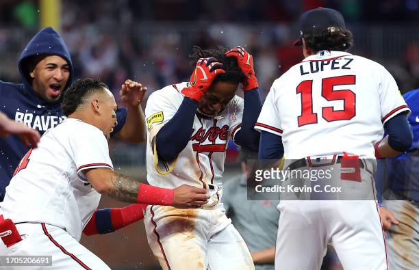 Ozzie Albies of the Atlanta Braves celebrates with teammatesafter hitting a RBI single to give the Braves a 6-5 win over the Chicago Cubs in the 10th...