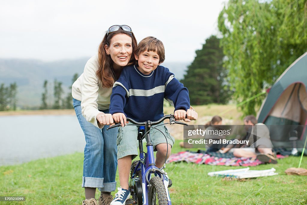 Boy on bicycle while on family camping trip