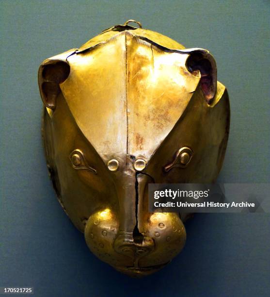 Silver rhyton in the shape of a bovine head with gold horns and rosette on the forehead. The muzzle, which has a pouring hole, is gold plated as were...