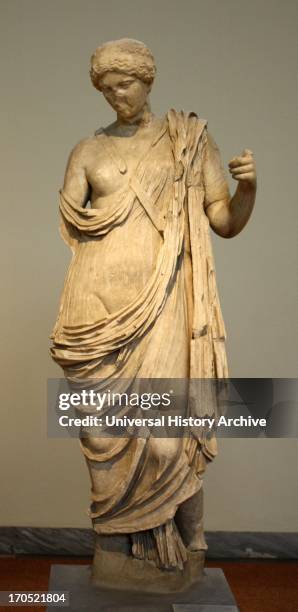 Statue of armed Aphrodite. Parian marble, found in Epidaurus. The sheath of the sword held in the goddess' raised right hand crosses her chest. 1st...