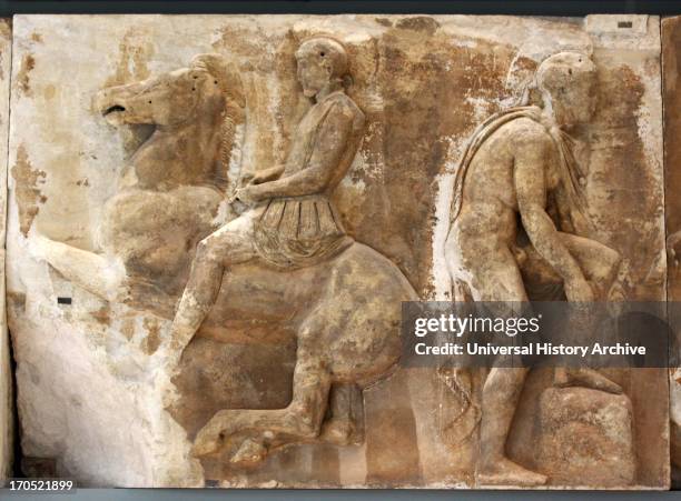 Horseman gallops towards the right. He is dressed as an hoplite with an anatomical cuirass with flaps made of leather, lion-shaped shoulder-straps...