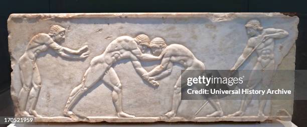 Base of a statue representing sports  two wrestlers, Relief of marble; ca 510 BC. National Archaeological Museum, Athens