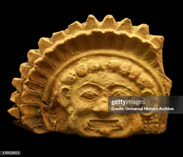 Terracotta antefix with relief representation of a gorgoneion and traces of the original colouration in yellow and black, late 6th century BC