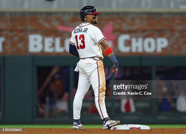 Ronald Acuna Jr. #13 of the Atlanta Braves reacts after stealing second base against Dansby Swanson of the Chicago Cubs in the 10th inning at Truist...