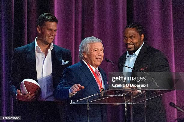 Players Tom Brady and Jerod Mayo look on as honoree Robert K. Kraft speaks on stage during the 2013 Carnegie Hall Medal Of Excellence Gala at The...