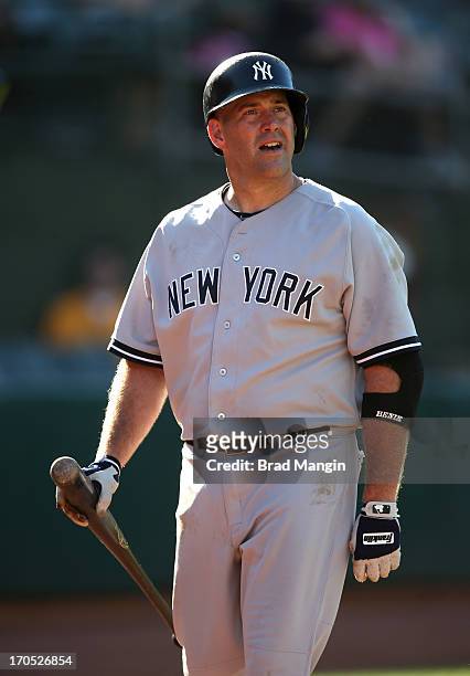 Kevin Youkilis of the New York Yankees walks back to the dugout after striking out against the Oakland Athletics during the game at O.co Coliseum on...