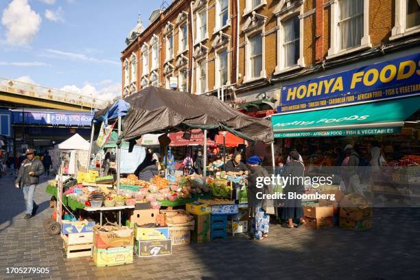 Shoppers at a fruit and vegetable market stall on Electric Avenue in the Brixton area of London, UK, on Friday, Sept. 22, 2023. As London flourished...