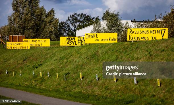 October 2023, Mecklenburg-Western Pomerania, Upahl: Signs reading "Here could be your village, Uprising or peace, No to asylum home, Think of our...