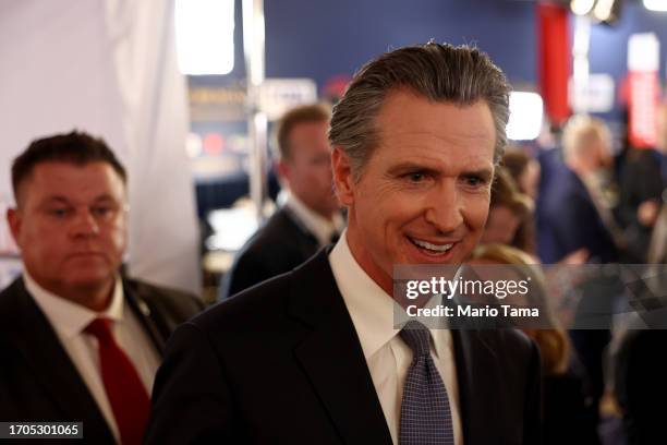 California Gov. Gavin Newsom talks to reporters in the spin room following the FOX Business Republican Primary Debate at the Ronald Reagan...