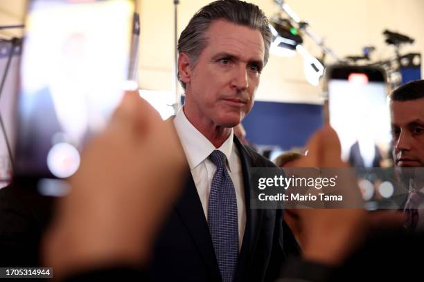 California Gov. Gavin Newsom talks to reporters in the spin room following the FOX Business Republican Primary Debate at the Ronald Reagan...