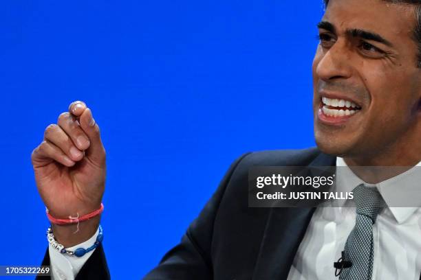 Britain's Prime Minister Rishi Sunak addresses delegates at the annual Conservative Party Conference in Manchester, northern England, on October 4,...