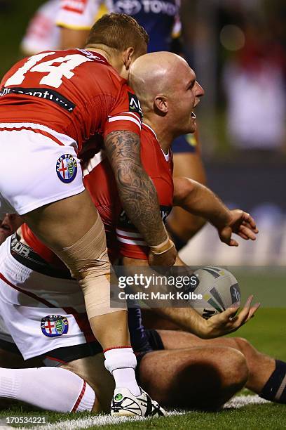 Michael Weyman of the Dragons celebrates scoring a try during the round 14 NRL match between the St George Illawarra Dragons and the North Queensland...
