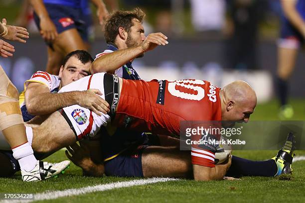 Michael Weyman of the Dragons scores a try during the round 14 NRL match between the St George Illawarra Dragons and the North Queensland Cowboys at...