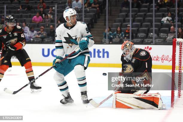 Justin Bailey of the San Jose Sharks deflects a shot on goal as Lukas Dostal of the Anaheim Ducks defends during the third period of a preseason game...