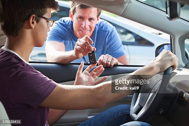 father handing son car keys - teenage boy looking out window stock pictures, royalty-free photos & images