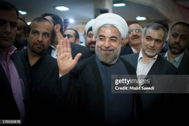 Iranian moderate presidential candidate, Hassan Rowhani waves as he leaves a polling station after voting in the first round of the presidential...