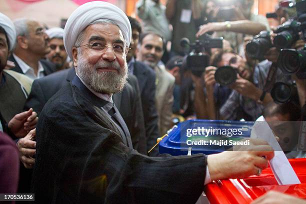 Iranian moderate presidential candidate, Hassan Rowhani casts his vote at a polling station during the first round of the presidential election on...