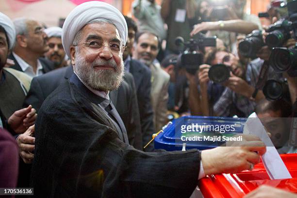 Iranian moderate presidential candidate, Hassan Rowhani casts his vote at a polling station during the first round of the presidential election on...