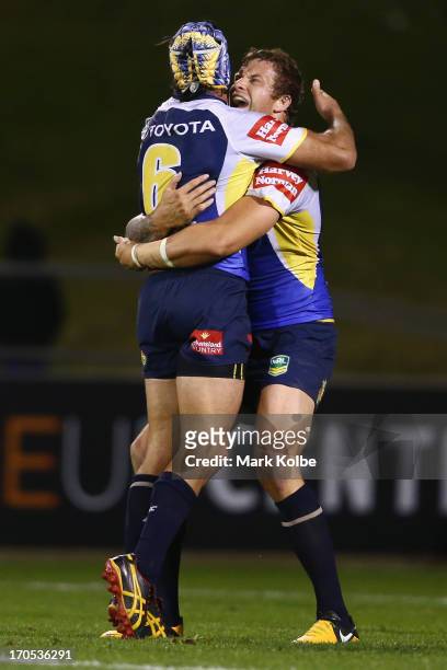 Johnathan Thurston and Ashton Sims of the Cowboys celebrate victory during the round 14 NRL match between the St George Illawarra Dragons and the...