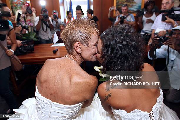 Corinne Denis and Laurence Cerveaux kiss each other after being declared married at Saint-Paul de la Reunion city hall during the first official gay...