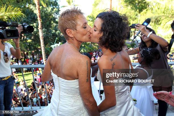 Corinne Denis and Laurence Cerveaux kiss each other after being declared married at Saint-Paul de la Reunion city hall during the first official gay...