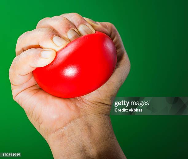 stress ball in hand - stress ball stock pictures, royalty-free photos & images