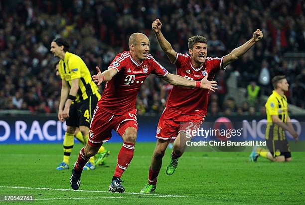 Arjen Robben of FC Bayern Muenchen celebrates scoring his side's second goal with team-mate Thomas Muller during the UEFA Champions League final...