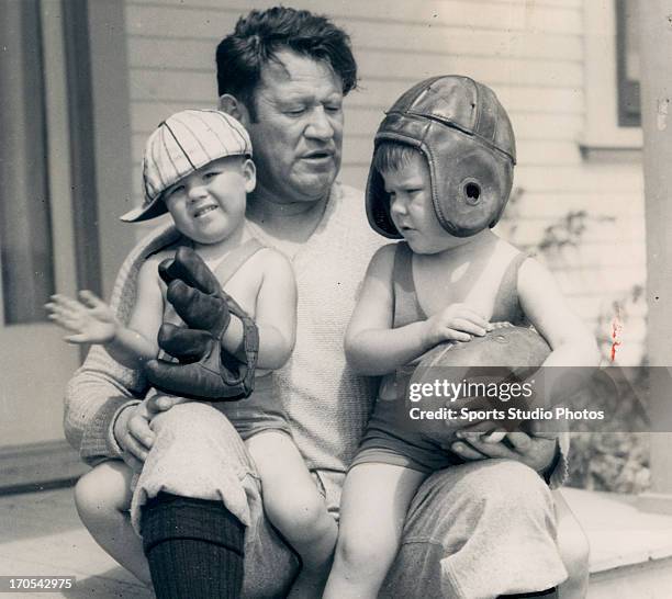 Olympic gold medalist Jim Thorpe poses with his sons Phil and Billy on September 3, 1931 in front of their home.