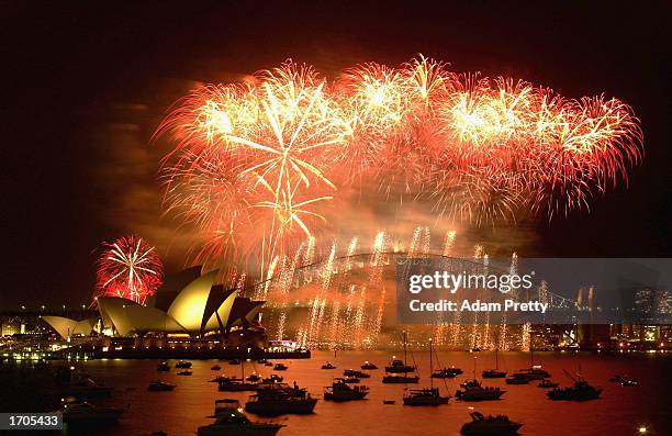 New Year's Eve fireworks explode in the sky above Sydney Harbour on December 31, 2002 in Sydney, Australia. A crowd of approximately 800,000 people...