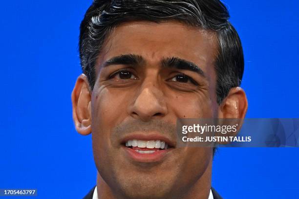 Britain's Prime Minister Rishi Sunak addresses delegates at the annual Conservative Party Conference in Manchester, northern England, on October 4,...