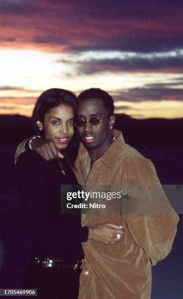 Portrait of American couple, Kimberly Porter and rapper Sean Combs, as they pose on the set of the 'Can't Nobody Hold Me Down' music video , Apple...