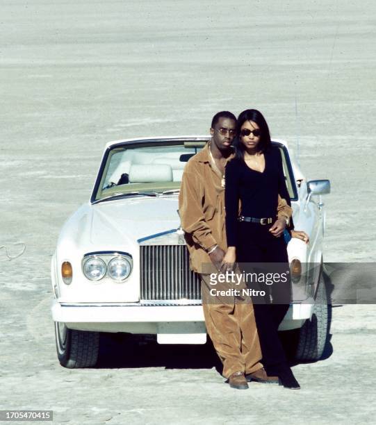 Portrait of American couple, rapper Sean Combs and Kimberly Porter , as they pose on the set of the 'Can't Nobody Hold Me Down' music video , Apple...