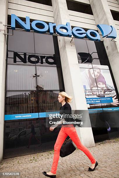 Pedestrians pass a sign outside a Nordea Bank Polska SA bank branch in Wroclaw, Poland, on Friday, June 14, 2013. PKO Bank Polski SA, Poland's...