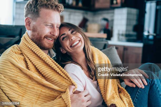 happy couple at home. - cobertor imagens e fotografias de stock