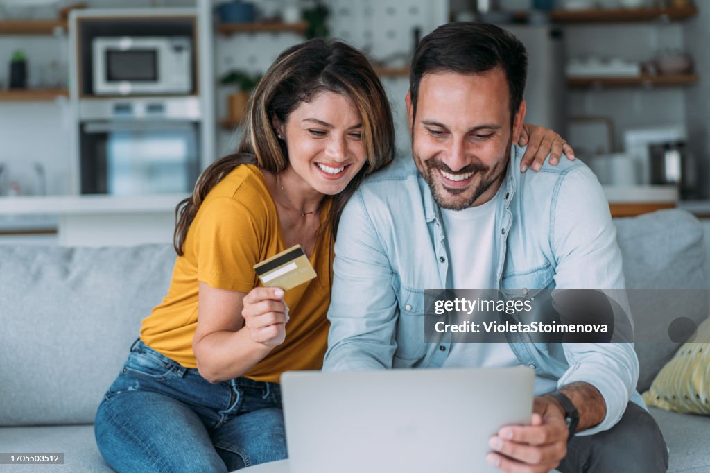 Lovely couple using laptop for online shopping.