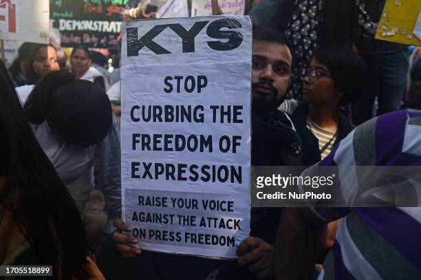 An Activist hold a placard during a protest by various students organizations against the raids of homes of journalists and writers belonging a news...