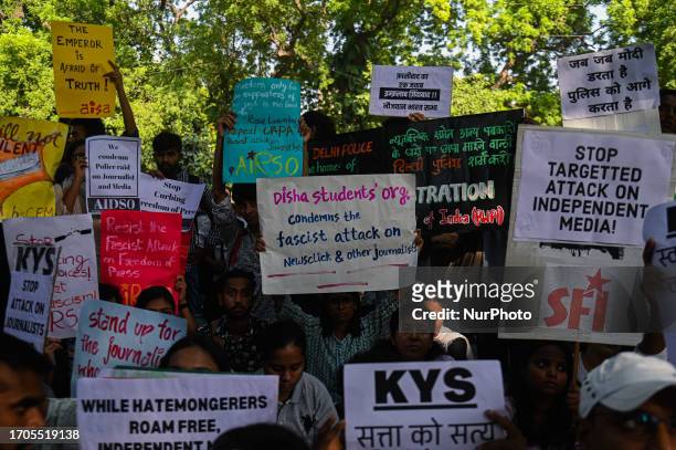 Activists of various student organizations hold placards in a protest against the raids of homes of journalists and writers belonging a news portal...