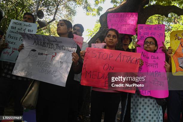 Activists of various student organizations hold placards in a protest against the raids of homes of journalists and writers belonging a news portal...