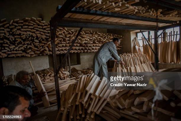 Kashmiri workers count bats before packing them in a bat factory on October 3, 2023 in Halmullah, 50 km, south of Srinagar, Indian administered...