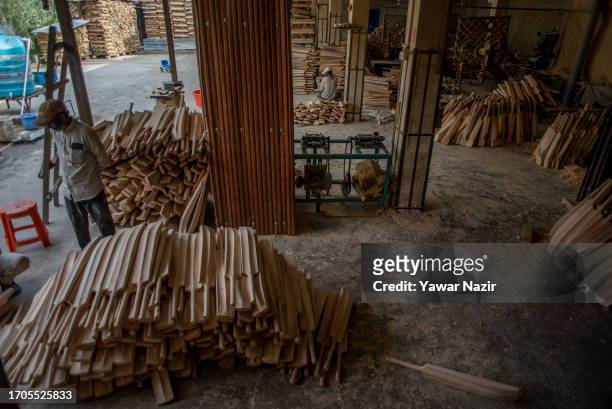 Workers make bats in a bat factory on October 3, 2023 in Halmullah, 50 km, south of Srinagar, Indian administered Kashmir, India. Kashmiri bat...