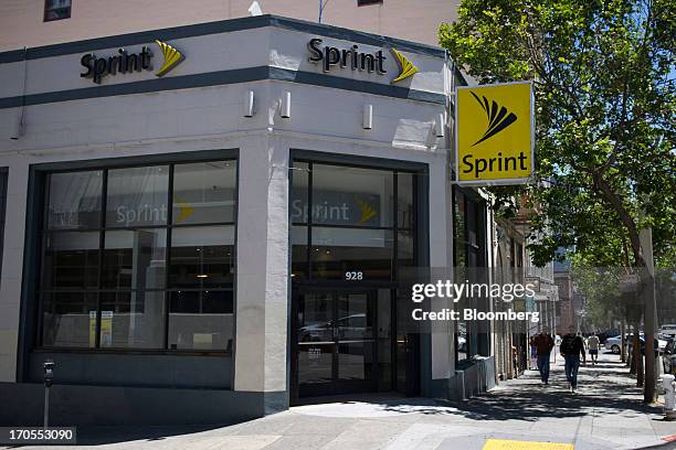 Pedestrians walk past a Sprint Nextel Corp. Store in San Francisco, California, U.S., on Thursday, June 13, 2013. SoftBank Corp. Chief Executive...